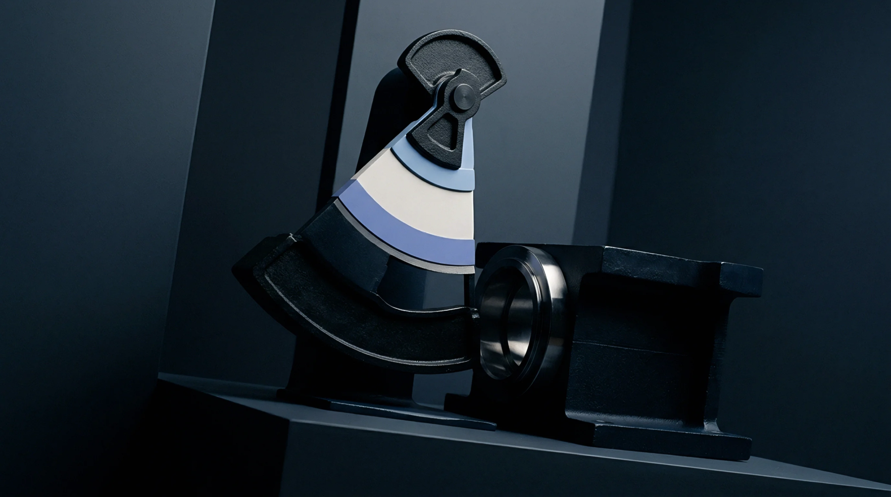A cast iron machined housing and a calibration instrument with layered colored arcs rest on a dark studio platform.
